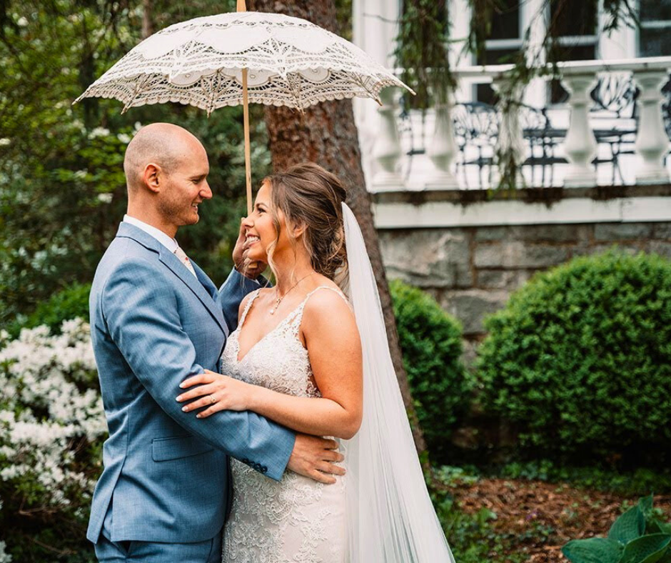 Young couple posing under an umbrella and lovingly looking into each others eyes