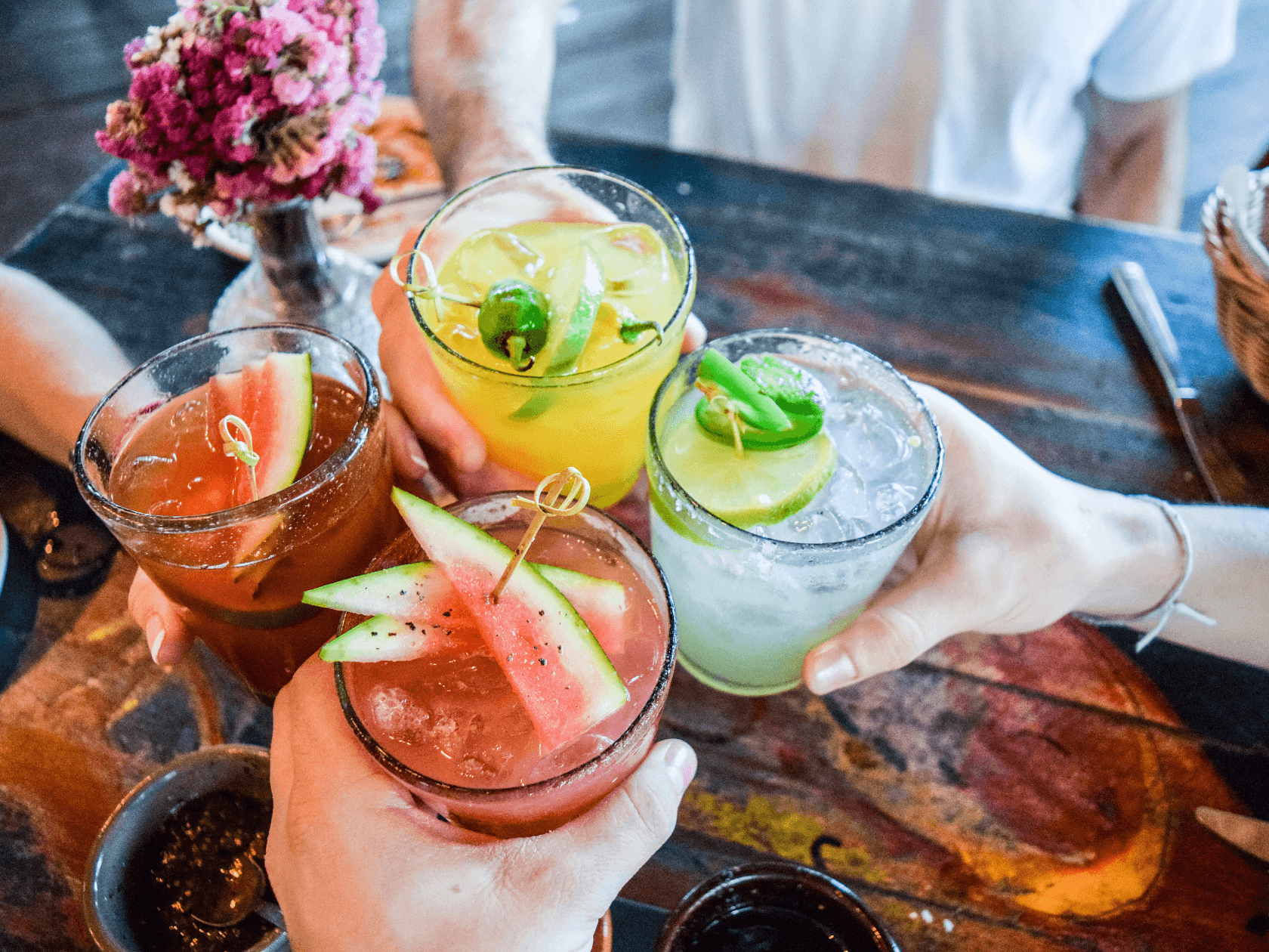 A group of friends cheering margaritas 